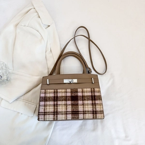 Detail of tweed and brown leather patchwork texture on a vintage crossbody bag