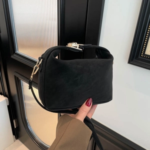 Minimalist black matte suede underarm bag with metal buckle and shoulder strap