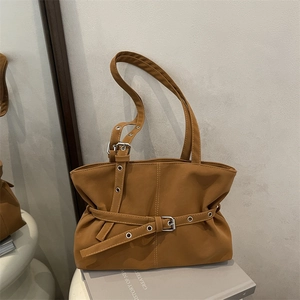 Minimalist caramel brown biker style underarm bag with pleated faux leather and metal eyelets