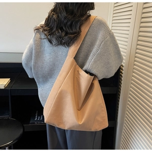 Detailed back view of a khaki oversized canvas tote bag showing wide shoulder strap