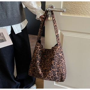 Detail of leopard print tote bag showing thick fabric texture and spacious interior