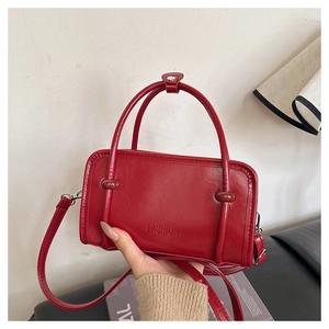 Detail of red square handbag with top handle and fashion logo for women fashion