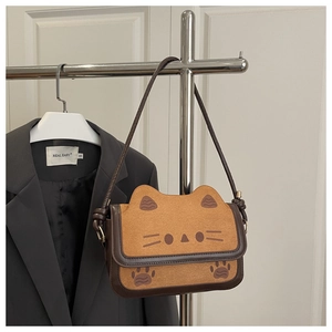 Detail shot of cute cat-shaped crossbody bag with soft faux leather and 3D ear accents