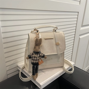 Cream white PU leather backpack with gold metal accent and a cute plush rabbit pendant