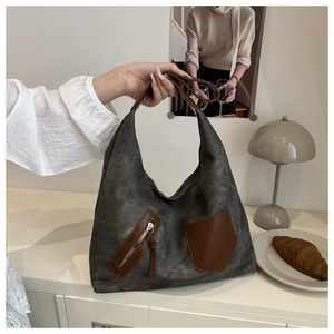 Detail of vintage canvas tote bag with brown leather accents and zipper pocket