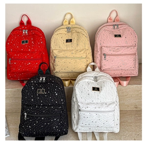 Detail of five stylish star-pattern backpacks in various colors on a minimalist display