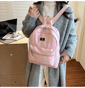 Pink casual backpack with silver star patterns shown in a lifestyle scene for daily use