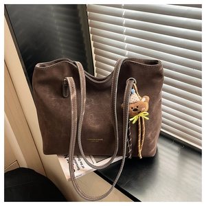 Large dark brown matte tote bag with contrast stitching and cute plush bear charm