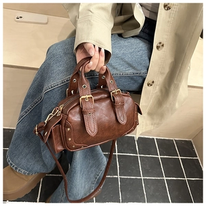 Retro brown small Boston bag detail showing vintage leather texture and metal buckles