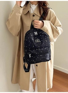 Mini black backpack with star print shown on model for casual daily use and travel
