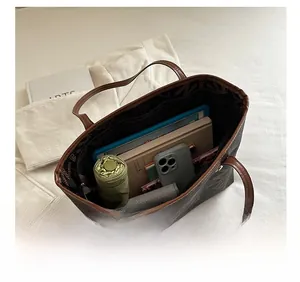 Interior view of large tote bag showing capacity for tablet, umbrella and books