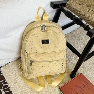 Chic yellow star pattern backpack with large capacity for women on cozy bedroom background
