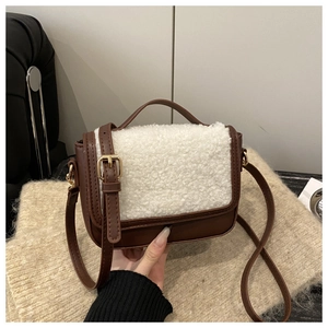 Detail of vintage saddle bag featuring brown leather and white faux shearling texture