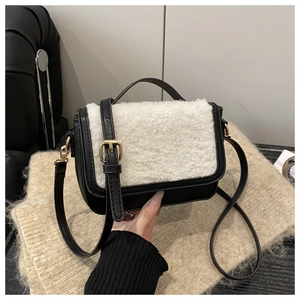 Detail of small saddle bag with black leather and white faux shearling fur textures