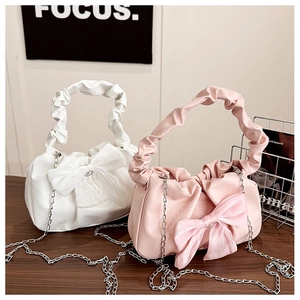 Detail of ruched cloud bags in ivory and pink with large decorative silk bows