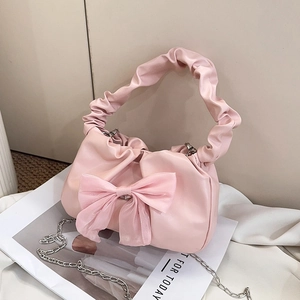 Pink pleated handbag featuring a large ribbon bow and elegant silver chain strap