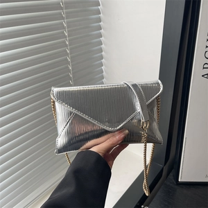 Metallic silver envelope clutch bag with vertical stripe texture and gold chain strap