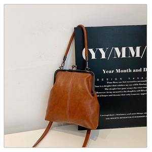 Detail of vintage brown doctor bag with metal frame closure and decorative stitching
