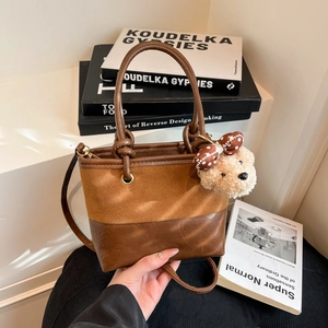 Suede patchwork tote bag for women with plush bear charm and adjustable shoulder strap
