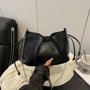 Minimalist black leather pleated shoulder bag with silver chain strap and drawstring detail