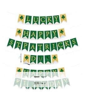 Macro detail of St. Patrick’s Day glitter shamrock banner with gold lettering on green