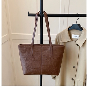 Detail showing dark brown faux crocodile texture on a large minimalist tote bag