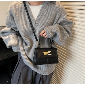 Classic black pebbled leather handbag with gold twist lock and crossbody strap for women