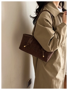 Detail of leopard print handbag featuring a unique knotted shoulder strap and gold accents