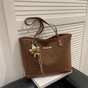 Chic leopard print matte tote bag with brown leather trim and cute plush bear charm