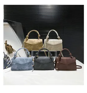 Detail shot of vintage Maillard crossbody bags with knotted handles in five colors