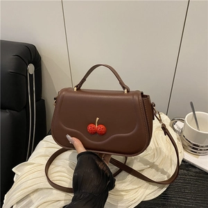 Vintage brown leather crossbody bag with 3D cherry buckle and curved base design