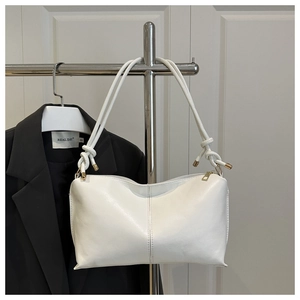 Détail du sac cabas blanc minimaliste avec poignée nouée et accents dorés