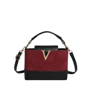 Chic burgundy suede handbag with black leather trim and golden metal V decoration