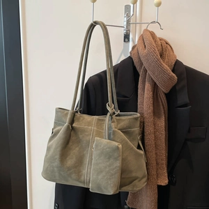 Olive green suede tote bag with contrast stitching and matching coin purse on hanger