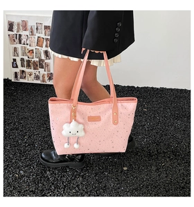 Pink star-patterned tote bag detail featuring cute cloud charm and silver star prints