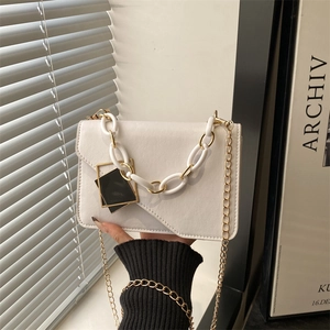 Minimalist white leather crossbody flap bag with stylish resin and gold chain handle