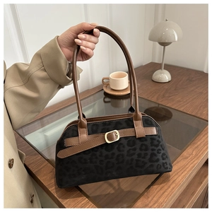 Detail of leopard print suede underarm bag with leather straps and metal buckle