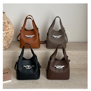 Quatre sacs seaux en marron, taupe, noir et café avec des fermoirs argentés