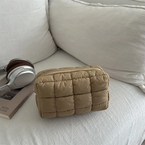 Quilted puffer makeup bag in camel brown color with a soft rectangular structure