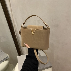 Elegant khaki matte leather bucket bag with gold V-clasp and adjustable shoulder strap
