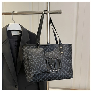 Detail of grey M-pattern tote bag with matching coin purse and 3D leather letter