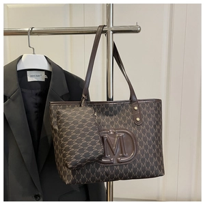 Detail view of dark coffee tote bag with M monogram print and matching zip pouch