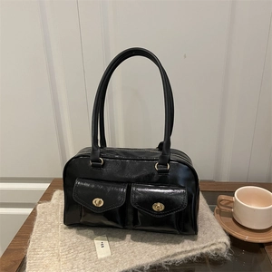 Chic black glossy underarm bag with double front pockets and gold locks on knit fabric