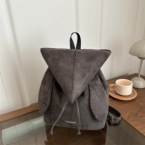 Minimalist dark grey faux suede backpack with rabbit ear charms and fashion logo
