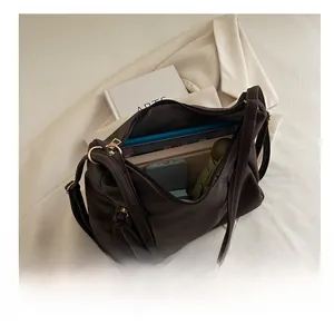 Deep coffee suede tote bag showing large capacity with phone, umbrella, and books inside