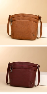 Close-up of vintage multi-layer bucket bag showing premium lychee grain and metal zippers
