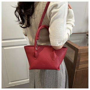 Red lychee pattern leather bucket bag shown on a model for daily crossbody styling