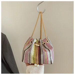 Detail of colorful striped woven bucket bag with gold chain and pearl drawstring