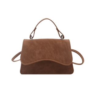Minimalist brown crossbody square bag with top handle in textured faux leather finish