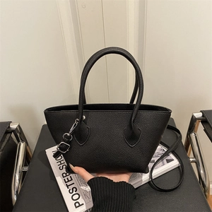 Chic black lychee grain leather bucket bag with top handles and adjustable shoulder strap